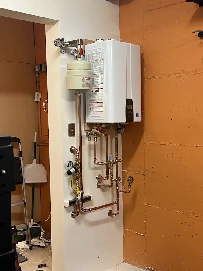 Plumbing technician inspecting water heater connections in Truth or Consequences